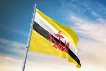Waving flag of Brunei in blue sky. Brunei flag for independence day. The symbol of the state on wavy fabric.