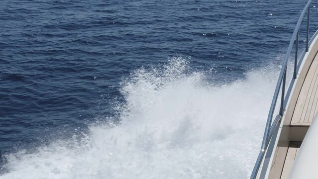 water flow after motor vessel, backwaters, deep blue sea and splashes, movement
