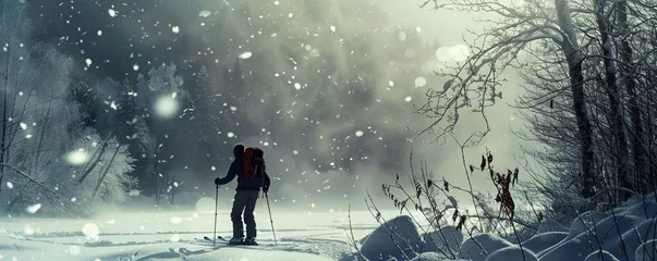 Zelfklevend Fotobehang Man backcountry skis through snowy environment © Svitlana