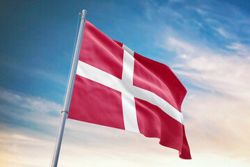 Waving flag of Denmark in blue sky. Denmark flag for independence day. The symbol of the state on wavy fabric.