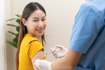 Health care, sick asian young woman getting syringe vaccine on arm, patient injection dose with...