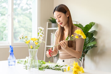 Flower arrangement, happy beautiful asian young woman florist hand making flower in vase, creating...