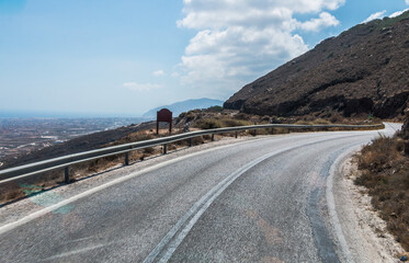 serpentine road in the mountains along the sea on the island of Santorini in Greece	
