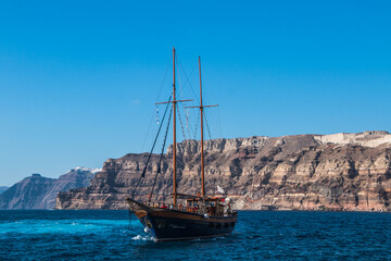 tourist vintage sailing yacht in the Aegean sea near the coast of Santorini island in Greece
