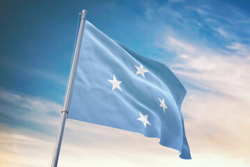 Waving flag of Micronesia in blue sky. Micronesia flag for independence day. The symbol of the...