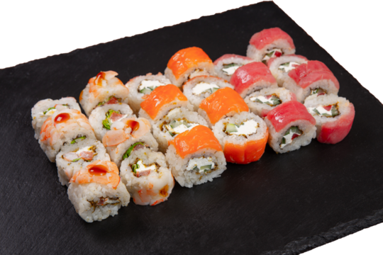Sushi set served on black stone tray. Various types of sushi rolls served on a slate slab. Isolated on white.