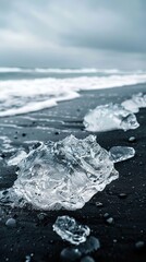 Piece of ice melting against black beach