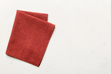 top view with red empty kitchen napkin isolated on table background. Folded cloth for mockup with copy space, Flat lay. Minimal style