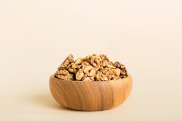 Fresh healthy walnuts in bowl on colored table background. Top view Healthy eating bertholletia concept. Super foods