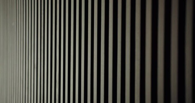 Closeup on wall decorated with wooden panels in apartment with modern interior. Using natural materials at home design. Background with wood decorative planks