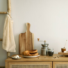 Interior design of kitchen space with rattan commode,  ladder, cutting board, baking, coffee...