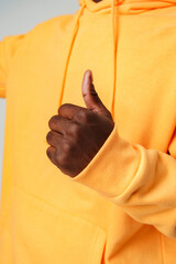 Man in Yellow Hoodie Giving Thumbs Up.