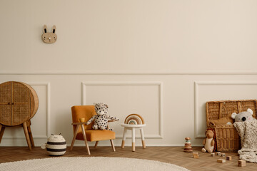 Minimalist composition of kids room interior with velvet orange armchair, braided baskets, round rug, white stool, beige wall with stucco and personal accessories. Home decor. Template. - obrazy, fototapety, plakaty