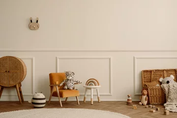 Selbstklebende Fototapete Höhenskala Minimalist composition of kids room interior with velvet orange armchair, braided baskets, round rug, white stool, beige wall with stucco and personal accessories. Home decor. Template.