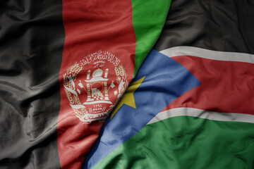 big waving national colorful flag of south sudan and national flag of afghanistan.