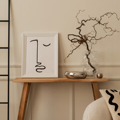 Interior design of living room interior with mock up poster frame, wooden bench, glass vase with branch, silver bowl, sculpture, black ladder, beige wall and personal accessories. Home decor. Template
