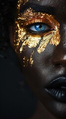 Fototapeta premium portrait with closeup of African American female with gold paint on face and body and golden against dark background