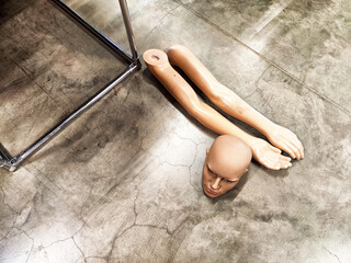 Disassembled Mannequin on Concrete Floor. Mannequin parts scattered on a polished surface