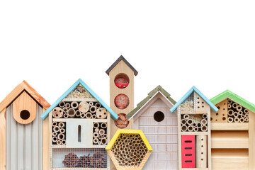 Row of colorful new bird houses, feeders and insect hotels