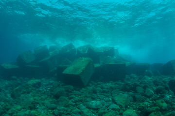 Underwater view of wall breaker blocks at Las Eras dive site entry, Tenerife, Canary Islands