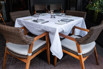 Interior of a summer terrace of restaurant. Table and chairs in empty cafe.