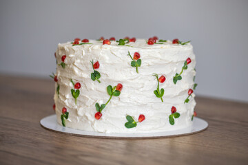 White homemade cake on a wooden table