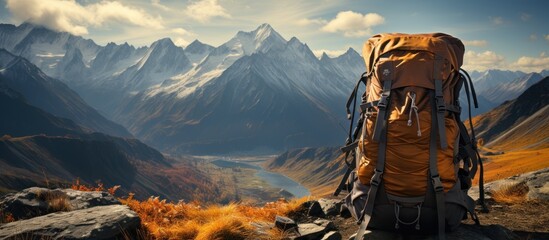 Mountain Climbing Gear with a Breathtaking Mountain Backdrop - obrazy, fototapety, plakaty