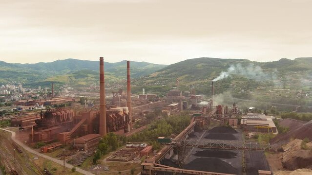 Drone Establishing Shot of an Old Iron Factory Nearby the City. Smokestack Fumes Emssion. Global Warming. Environmental Issues. Zenica, Bosnia and Herzegovina, Europe