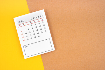 Calendar page for October 2024 on a yellow and brown.