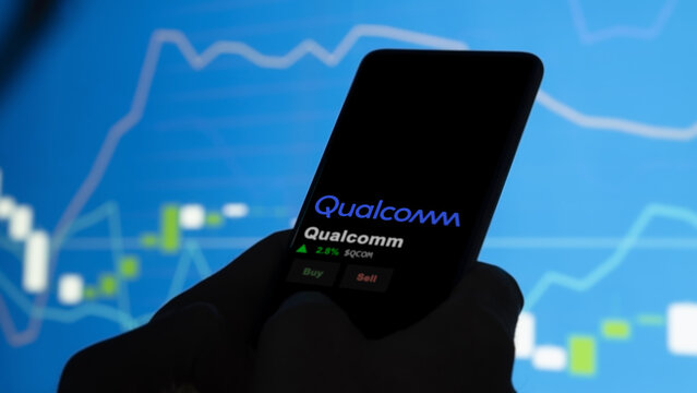 Qualcomm on the screen of an exchange. Qualcomm price stocks, $QCOM on a device.