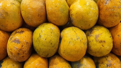 Close up pile of tasty fresh oranges sold at the market as a background.