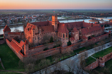 Malbork castle over the Nogat river at sunset, Poland - 761487518