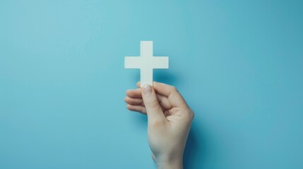 Person holding paper cross, suitable for religious concepts