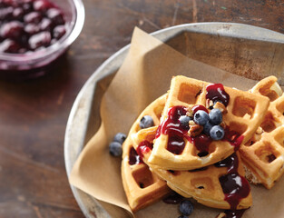 Blueberry waffles on wax paper and plate