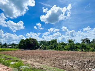 Aerial view of farmland in rural Thailand Blue skies, clear air, lush green trees and farmland preparing the soil for planting. The beautiful tranquility of the countryside.
