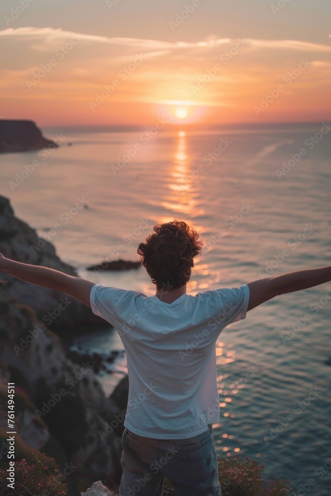 Poster a man standing on a cliff looking out over the vast ocean. suitable for travel and adventure themes