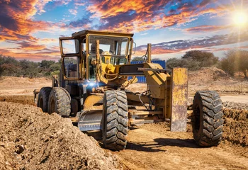 Foto op Canvas yellow grader digging the earth on a construction site at a diamond mine © poco_bw