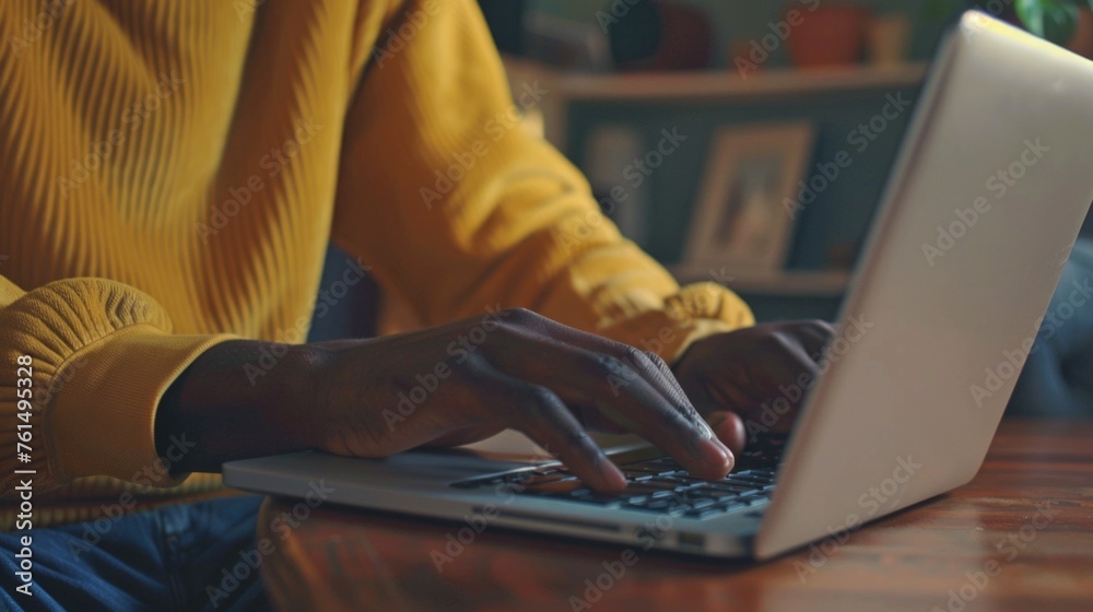 Poster A person typing on a laptop computer at a table. Suitable for technology and remote work concepts