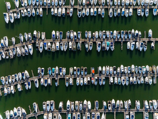Yacht marina with boats lined up along the pontoon - obrazy, fototapety, plakaty