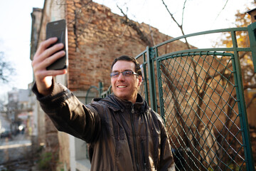 Happy Caucasian man, video chatting on smartphone 