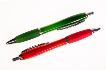 red and green pen on a white background