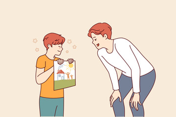 Little boy drew picture in honor of father day and congratulates stepfather on family holiday. Creatively gifted child showing off own creation with smile to happy man on father day
