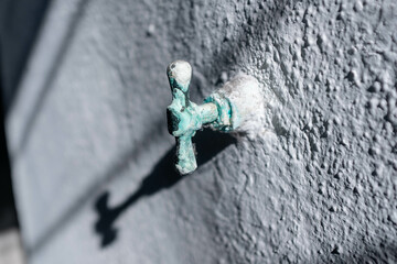 An old unused handle to an imbedded piping inside a wall