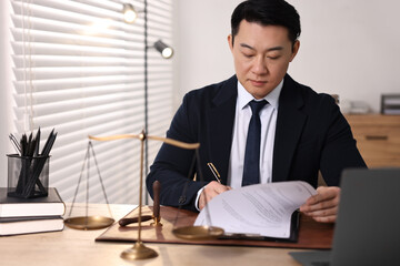 Fototapeta premium Notary writing notes at wooden table in office