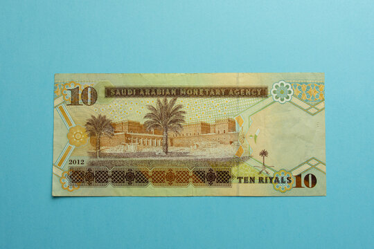 Saudi Arabia 10 riyals banknote on a blue background. 