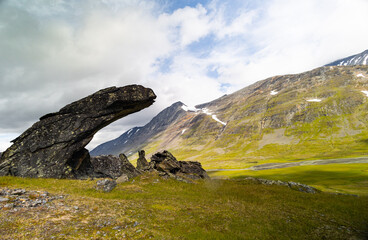 Fototapeta na wymiar Large rock formation in Sarek National Park, Sweden. Summer landscape of Northern Europe mountain wilderness area.