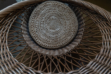 Wicker basket made of rattan in the interior of a cafe - obrazy, fototapety, plakaty