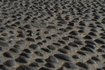 Background texture of a stone pavement with small holes, close-up portugal, madeira, 