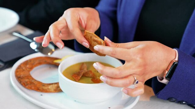 Turkish soup, The woman throws bread crumbs into the soup and drinks it.