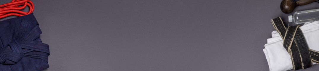 Traditional Martial Arts Attire and Equipment Set on Gray Background — Minimalist Sports Banner...